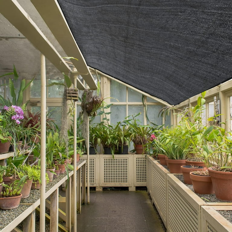Shade cloth protecting balcony plants from strong sunlight